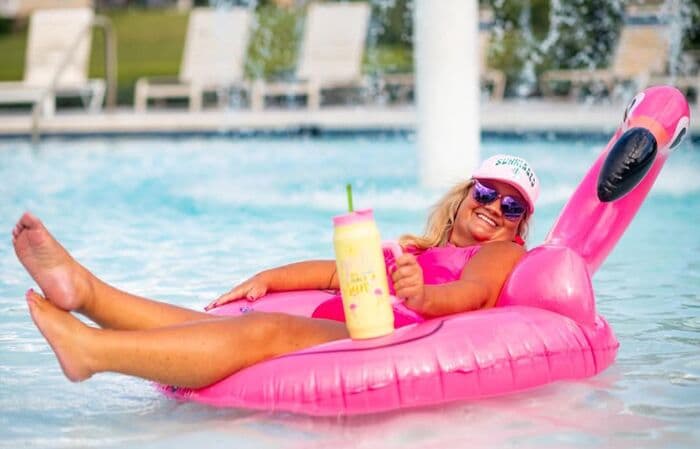Susan Horne relaxing by the pool with a flamingo float
