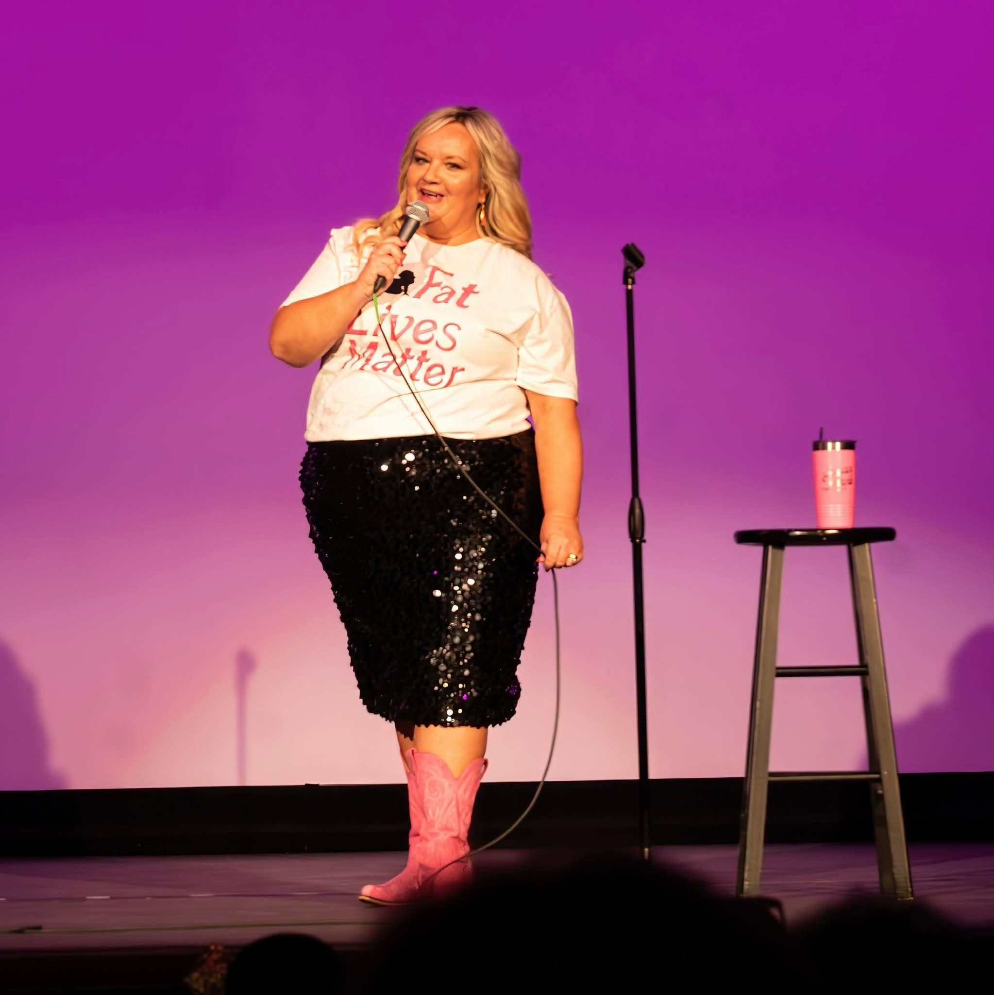 Susan Horne performing live on stage with pink cowboy boots